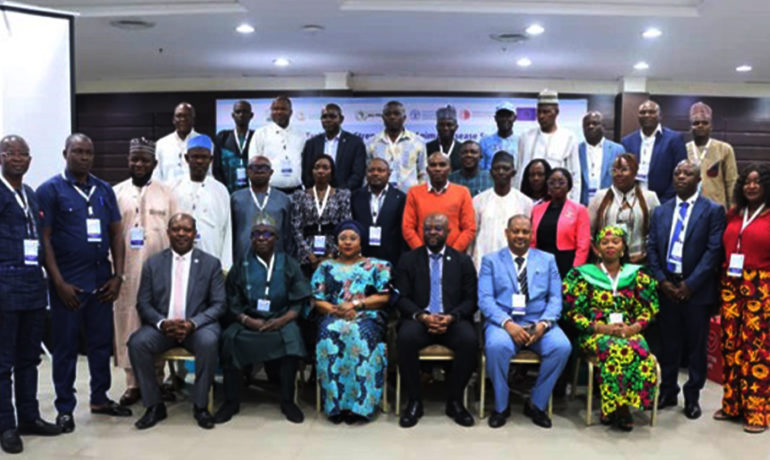 Group photo of approximately 30 West African delegates in professional attire, seated and standing, at a regional workshop focused on animal disease control